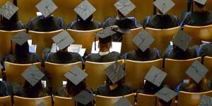 Aerial view of graduating students seated in theatre seating